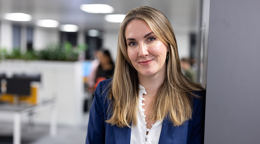 Female lawyer leaning on a wall