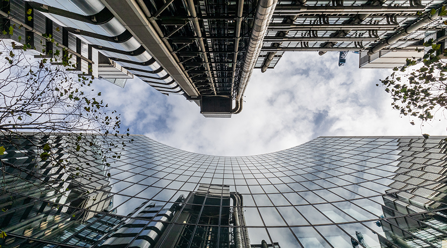 Skyscrapers image taken from below with sky reflection