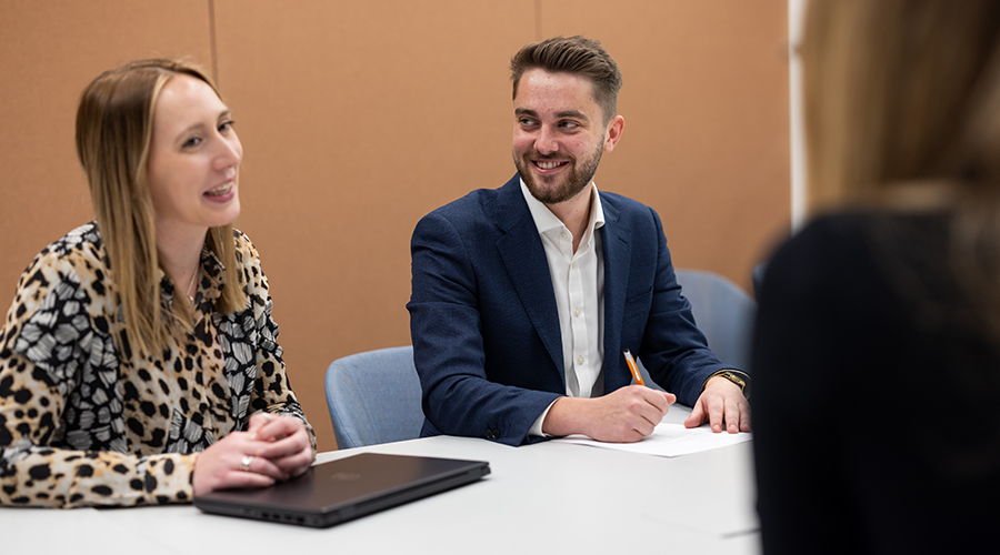 Lawyer and client sitting at the table, chatting and smiling