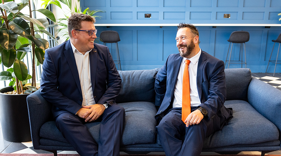 Lawyer and client sitting on the sofa, chatting and smiling