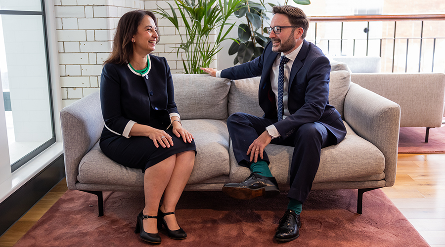 Lawyer and client sitting on the sofa chatting and smiling