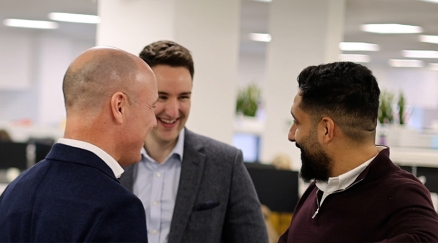 Group of three lawyers chatting and smiling