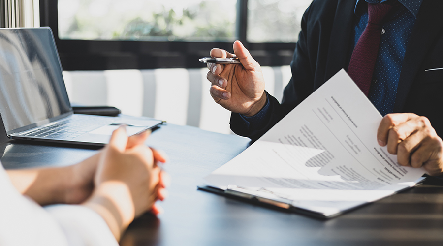 Two people signing a contract