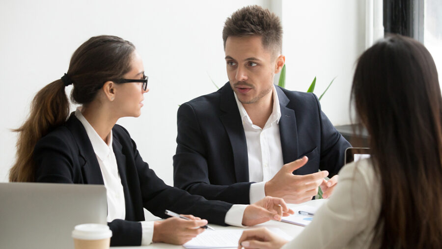 Image of three people having a mediation meeting