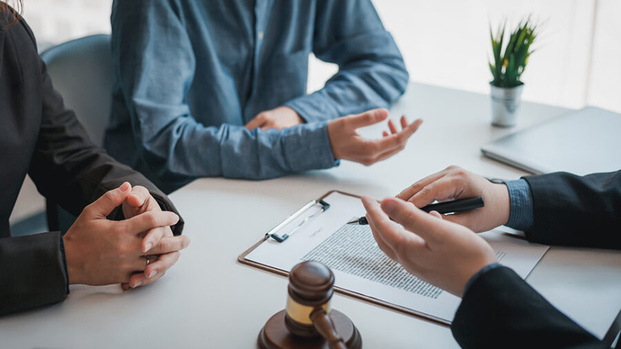 People discussing a contract at a table