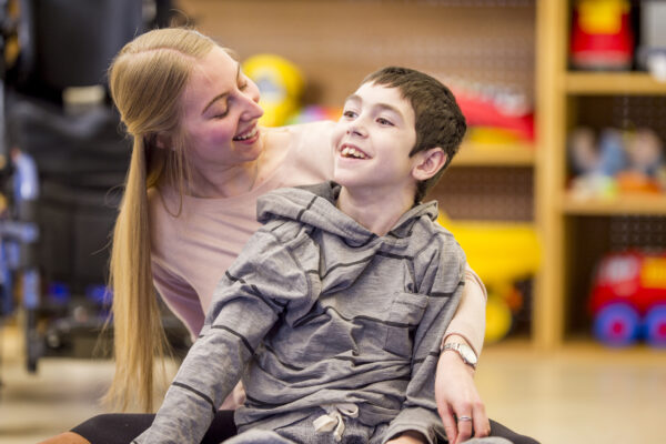 A photo of a carer with a disabled child