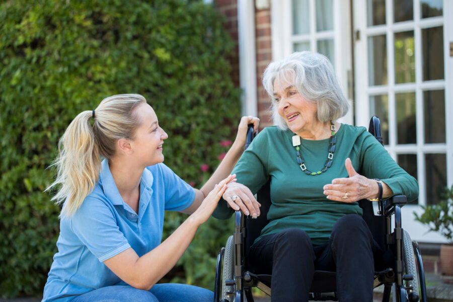 Carer with a woman in a wheelchair.