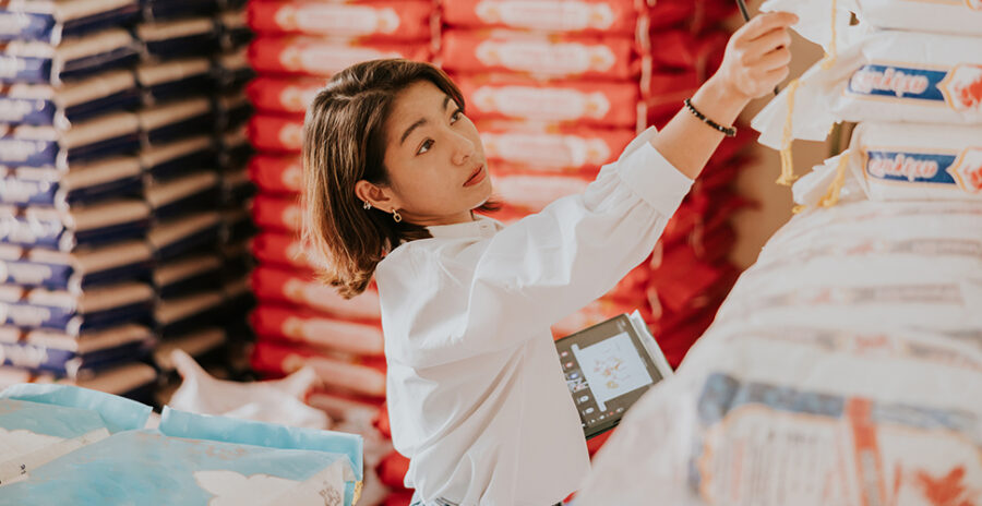 A woman checking items at a business