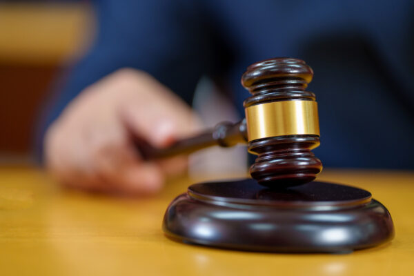 close up male Judge hitting Gavel off a block in courtroom, law and Justice concept