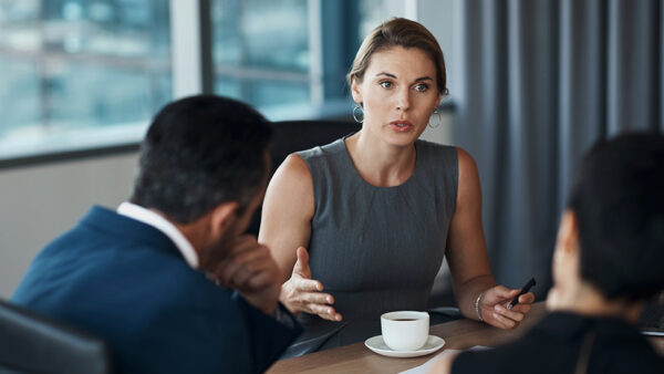 Clients in an office with lawyer sitting at table, discussing