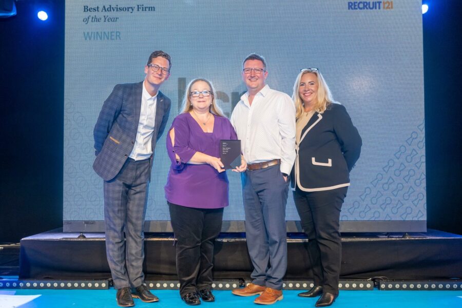 Group of four people on a stage, winning a Tech award