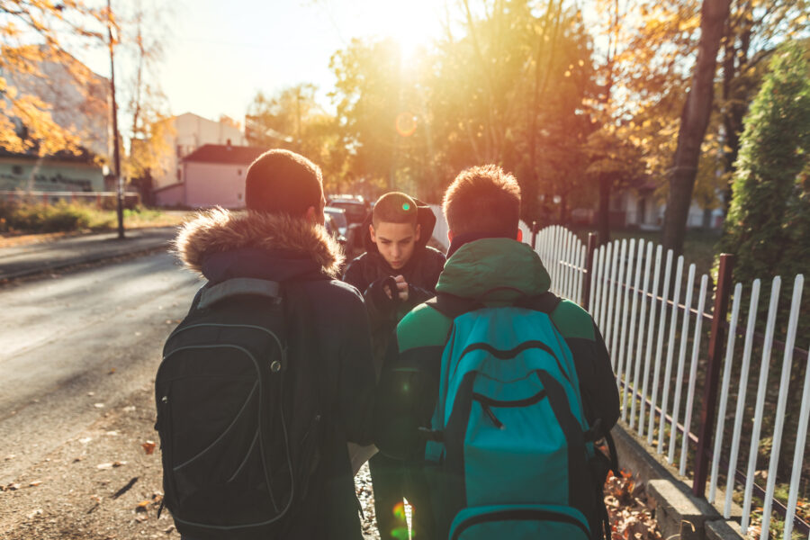 Three male schoolkids outside