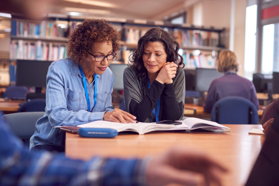 Two teachers discussing their reports