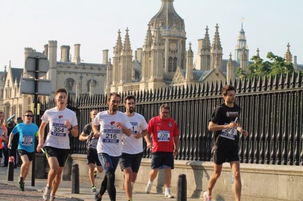 Runners sprinting along Trumpington Road