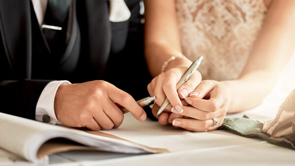 Couple getting married and signing documents