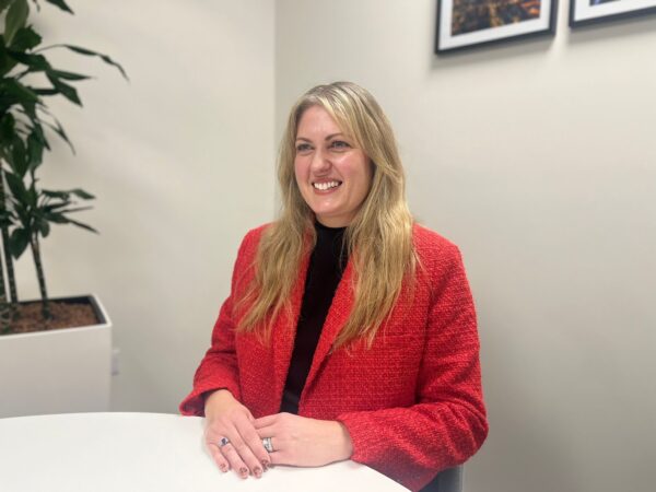 Female partner sitting at the desk, in a meeting, smiling