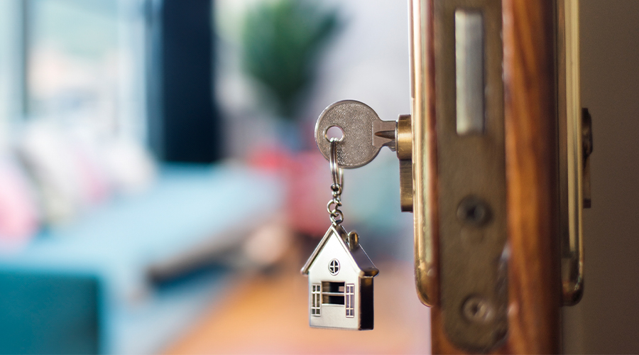 Picture of a house key in a door