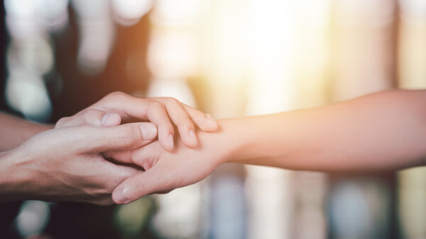 Two people holding hands