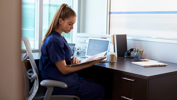 Healthcare practitioner sitting at desk working