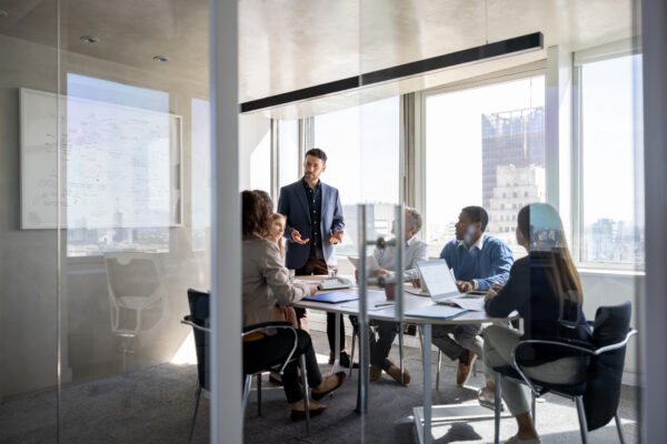 Business man talking to a group of people in a meeting a the office